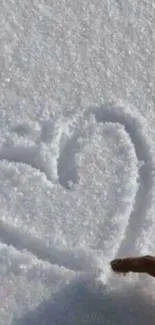 A heart shape drawn in fresh snow with a finger.