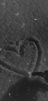 Heart drawn in snow with a dark, artistic touch.