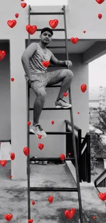 Man on ladder with red floating hearts in urban scene wallpaper.