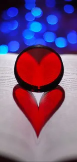 Heart shape reflection on book with blue bokeh lights.