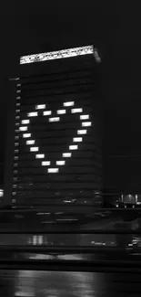 Black and white image of a building with a heart-shaped light display.