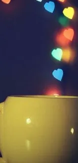 Yellow mug with colorful bokeh heart lights floating above.