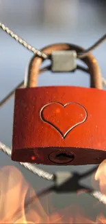 Red heart-shaped lock on a fence, perfect for a romantic mobile wallpaper.