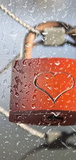 Red heart lock with raindrops on a fence.