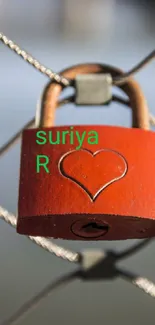 Red heart lock on a wire fence with engraved heart.