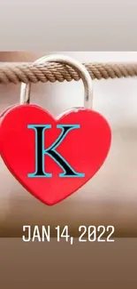 Heart-shaped lock with letter K on a rope in vibrant red color.