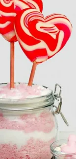 Two heart-shaped candies in a jar.