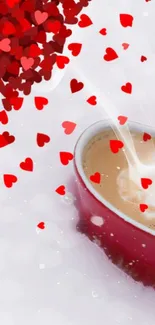 Heart-shaped mug in snow with falling red hearts.