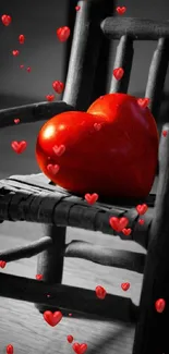 Red heart resting on a wooden chair in artistic wallpaper.