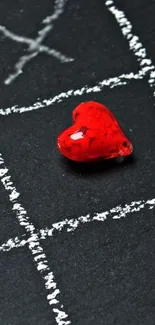 Red heart on a chalkboard with tic-tac-toe design.