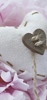 Fabric heart on pink flower petals, creating a romantic and gentle vibe.