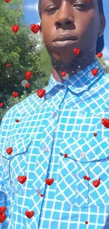 Man in blue patterned shirt with red hearts overlay.