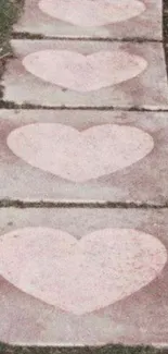 Heart-themed path with pink hearts on stone tiles.