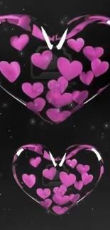 Mobile wallpaper with vibrant pink hearts on a black background.