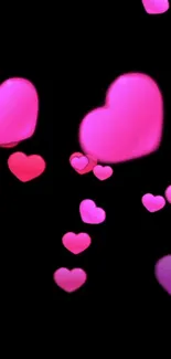 Pink and red hearts on black mobile wallpaper.