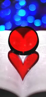 Red heart reflection on book with blue bokeh background.