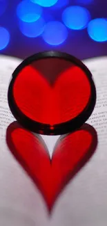 Heart-shaped shadow on a book with blue bokeh lights.