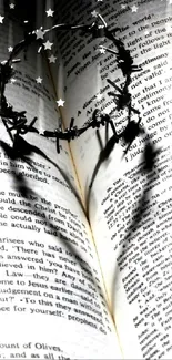 Crown of thorn casting heart shadow on open Bible pages.