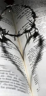 Crown of thorns casting heart shadow on open Bible.