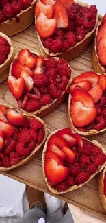 Heart-shaped berry tarts with strawberries and raspberries.