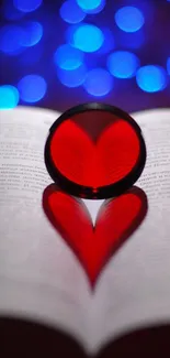 Heart-shaped red reflection on an open book with blue bokeh background.