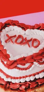 Heart-shaped cake with red frosting and 'XOXO' decoration.