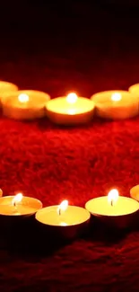 Heart-shaped candles on dark red background