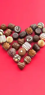 Heart-shaped chocolate collection on bright red background mobile wallpaper.