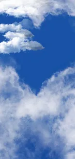 Heart-shaped cloud set against a vivid blue sky.