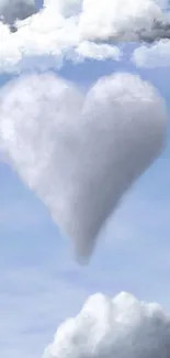 Heart-shaped cloud in blue sky with white clouds floating gently.