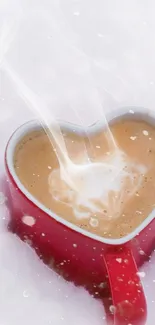 Heart-shaped coffee mug steaming against a snowy backdrop.