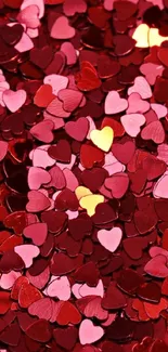 Colorful heart-shaped confetti wallpaper with red and pink hues.