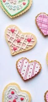 Heart-shaped cookies with pastel decorations on a white background.