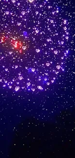 Heart-shaped purple fireworks light up the night sky in a stunning display.