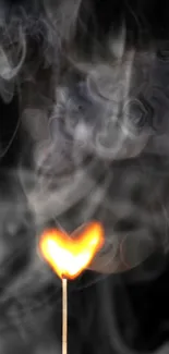 Heart-shaped flame with artistic smoke on black background.