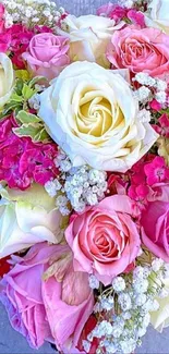 Heart shaped floral arrangement with vibrant pink and white roses.