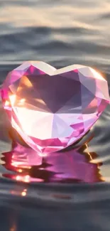 Heart-shaped pink gem floating on water.