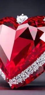 Heart-shaped red gemstone adorned with silver accents on a mobile wallpaper.