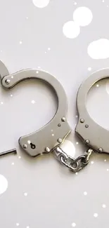 Heart-shaped handcuffs in a minimalist style on a white background.