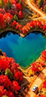Heart-shaped lake with vibrant red foliage in autumn.
