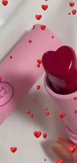 Heart-shaped pink lip balm on a white surface.