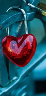 Red heart-shaped lock on a fence with blue tones.