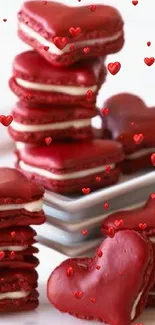 Red heart-shaped macarons stacked on a plate.