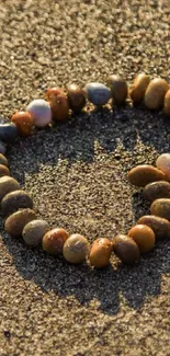 Heart shape made of pebbles on sandy beach.