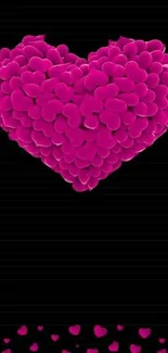 Magenta petal heart on black wallpaper.