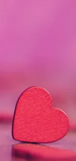 Pink heart-shaped mobile wallpaper with vibrant hues.