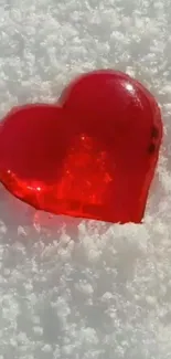 Red heart-shaped ice on snowy background wallpaper.