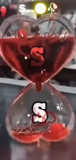 Heart-shaped red liquid hourglass wallpaper for mobile screens.