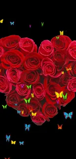 Heart-shaped arrangement of red roses on a black background.