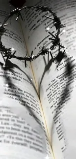 Heart-shaped shadow from thorns on an open Bible.